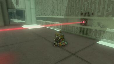 Kneel underneath the moving red laser