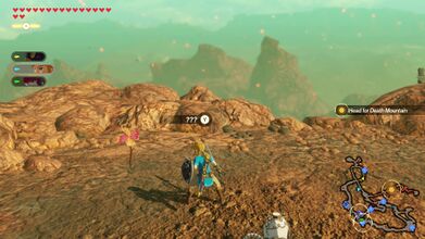 After crossing the large bridge with a Moblin, while heading to Death Mountain, the pinwheel is off to the west.