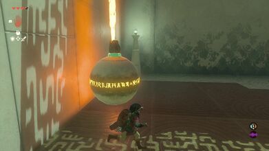 Drop down and attach the Flame Emitter to the large Orb and bring it towards the wall