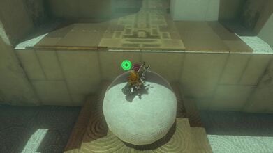 Jump onto the stone ball and then over the gap